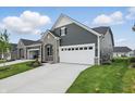 Attractive home featuring stone accents, neutral siding, a two car garage, and a well maintained lawn at 16969 Cole Evans Dr, Noblesville, IN 46060