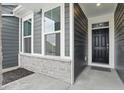 This home features a black front door, well placed windows, stone accents, and house numbers at 16969 Cole Evans Dr, Noblesville, IN 46060