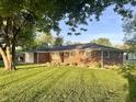 Brick home with green lawn, and garage, surrounded by mature trees at 2892 S State Road 267, Plainfield, IN 46168