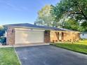 Lovely brick house with an attached garage and beautiful landscaping at 2892 S State Road 267, Plainfield, IN 46168