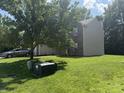 Attractive two-story home showcasing a lush lawn, mature tree, and partial brick facade at 17902 Cristin Way, Westfield, IN 46062