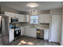 Modern kitchen featuring white cabinets, stainless steel appliances, and a bright window above the sink at 17902 Cristin Way, Westfield, IN 46062