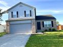 Two-story home with brick accents, neat landscaping, and a two-car garage at 1327 Blue Ridge Ln, Brownsburg, IN 46112