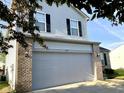 Close-up of the home's garage and exterior details with the house number above the garage door at 1327 Blue Ridge Ln, Brownsburg, IN 46112