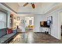 Bright living room featuring hardwood floors, built in shelves, and an open floor plan at 1433 E Fletcher Ave, Indianapolis, IN 46203