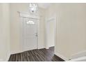 Bright entryway featuring hardwood floors and white trim at 1901 N Tillotson Ave, Muncie, IN 47304