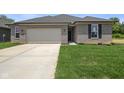 Inviting home with green lawn, concrete driveway, and a two-car garage providing ample parking at 2184 Galleone Way, Plainfield, IN 46168