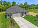 Attractive home featuring manicured lawn, a concrete driveway, and a two-car attached garage at 2184 Galleone Way, Plainfield, IN 46168