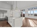 Bright kitchen with white cabinetry, quartz countertops, gold hardware, stainless appliances at 1155 S Rangeline Rd # 504, Carmel, IN 46032