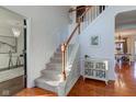 Elegant staircase with a white railing and hardwood floors at 12106 Cabri Ln, Fishers, IN 46037