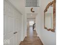 Bright entryway with hardwood floors, leading into a light-filled home with modern finishes at 2898 Creekridge Ct, Columbus, IN 47201