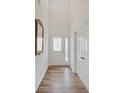 Bright entryway features wood-look flooring, decorative mirror, and access to coat closet at 2898 Creekridge Ct, Columbus, IN 47201