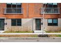Modern townhomes with red brick and neutral accents, complemented by young trees and tidy landscaping at 806 7Th St, Columbus, IN 47201