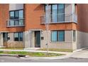 Detailed exterior view of brick townhome, highlighting private entrance, balcony, and modern design elements at 822 7Th St, Columbus, IN 47201