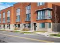 Street view of modern townhomes with brick exteriors, showcasing balconies and fresh landscaping at 822 7Th St, Columbus, IN 47201