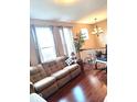 Cozy living room featuring a comfortable sofa, hardwood floors, and a bright chandelier at 6343 Central Blvd, Whitestown, IN 46075