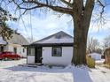 Lovely home exterior with snowy landscape and mature tree at 5845 Rawles Ave, Indianapolis, IN 46219