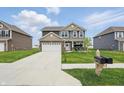 Two-story home featuring a well-manicured lawn and mailbox at 211 Walker Dr, Whiteland, IN 46184