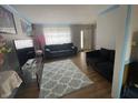 Spacious living room with hardwood floors, large rug, comfortable couches, and ample natural light at 6951 Governors Point Blvd, Indianapolis, IN 46217