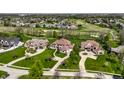 Panoramic aerial view showcasing upscale homes nestled among lush greenery and a golf course at 11492 Hanbury Manor Blvd, Noblesville, IN 46060