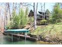 Picturesque waterfront with a private boat dock featuring a covered slip and scenic views of the lake at 6486 Coyote Dr, Nineveh, IN 46164
