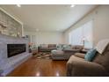 Spacious living room with a stone fireplace, hardwood floors, and ample seating at 2925 Highwoods Dr, Indianapolis, IN 46222