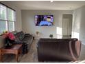 Spacious living room featuring wood laminate floors, two couches, and natural light at 7108 Parkstay Ct, Indianapolis, IN 46113