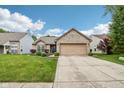 Charming brick home features a two-car garage, manicured lawn, and a welcoming entrance at 778 Kingston Cir, Brownsburg, IN 46112