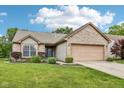 Charming brick home features a two-car garage, manicured lawn, and a welcoming entrance at 778 Kingston Cir, Brownsburg, IN 46112