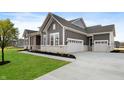 Gray farmhouse exterior with white trim, stone accents, and a large driveway at 11362 Selsey Rd, Fishers, IN 46040