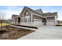 Gray two-story house with attached garage and stone details at 11362 Selsey Rd, Fishers, IN 46040