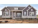 Gray two-story house with white accents and stone facade at 11362 Selsey Rd, Fishers, IN 46040