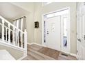 Bright foyer with wood flooring and a staircase to the second floor, offers a welcoming entrance at 19140 Golden Meadow Way, Noblesville, IN 46060