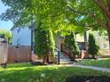 Green house with a wooden fence and manicured lawn at 2133 N Park Ave, Indianapolis, IN 46202