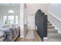 Bright entryway with gray accent wall and hardwood floors at 10561 Sand Creek Blvd, Fishers, IN 46037