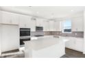 Modern kitchen featuring white cabinets, stainless steel appliances, and a large island at 573 Carroll St, New Whiteland, IN 46184