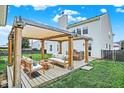 Inviting backyard patio with stylish pergola, comfortable seating, and outdoor grill, perfect for relaxation and entertaining at 1560 Cold Spring Dr, Brownsburg, IN 46112