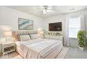 Bright bedroom featuring a plush bed, modern decor, and ample natural light from the window, creating a serene space at 1560 Cold Spring Dr, Brownsburg, IN 46112