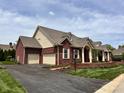 Beautiful brick home with attached two-car garage and manicured landscaping at 7936 Beaumont Green Pl, Indianapolis, IN 46250