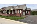 Well-maintained red brick house with a driveway and manicured landscaping, showcasing its appealing curb appeal at 7942 Beaumont Green Pl, Indianapolis, IN 46250