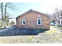 Rear exterior view of a brick home featuring two windows and a yard area at 3612 Schofield Ave, Indianapolis, IN 46218
