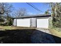 Spacious detached garage with two white doors, providing ample parking and storage space at 3612 Schofield Ave, Indianapolis, IN 46218