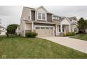 Charming two-story home featuring a two-car garage and a well-manicured lawn at 6748 Fallen Leaf Dr, Whitestown, IN 46075