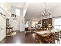 Open-concept living and dining area with high ceilings, dark wood floors, and modern decor at 11193 Harriston Dr, Fishers, IN 46037