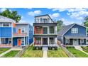 Modern three-story home with eye-catching design and balconies on the second and third floor at 1218 Orange St, Indianapolis, IN 46203