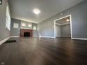 Bright living room with hardwood floors, a fireplace and an open floor plan for easy entertaining at 1702 Barth Ave, Indianapolis, IN 46203