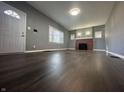 Spacious living room boasts hardwood floors, a decorative fireplace and abundant natural light at 1702 Barth Ave, Indianapolis, IN 46203