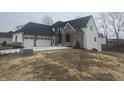 Attractive home featuring a three-car garage, stone detailing, and a well-maintained lawn at 719 Wexford Hill Ct, Westfield, IN 46074