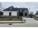 Beautifully designed home with stone and siding exterior, dormer windows, and a concrete driveway at 719 Wexford Hill Ct, Westfield, IN 46074
