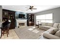 Comfortable living room with a fireplace, built-in bookshelves, and neutral tones, creating a relaxing atmosphere at 9955 Woodstock Way, Fishers, IN 46037